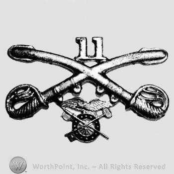 Insignia consisted of crossed sabres, number 11 above and a winged wheel below.
