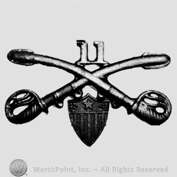 Insignia consisted of crossed sabres and number 11 above and a shield below.