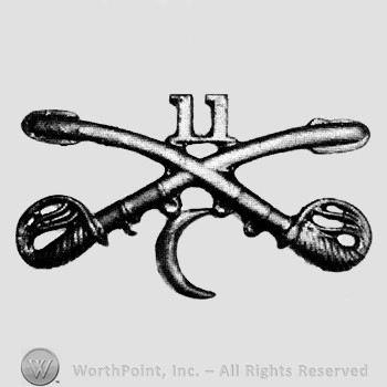 Insignia consisted of crossed sabres and number 11 above and crescent below.