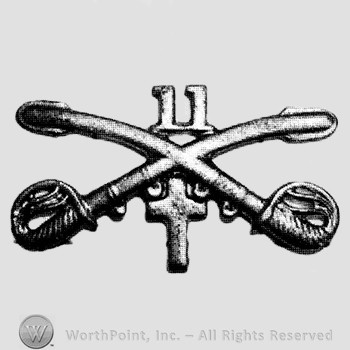 Insignia consisted of crossed sabres and number 11 above and a cross below.