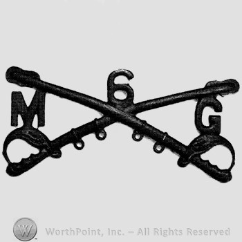 Insignia consisted of crossed sabres and number 6 above; letter M on the left and letter G on the right.