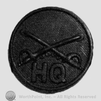Disc with crossed sabres and letters HQ below.