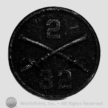 Disc with crossed sabres and number 2 above and number 32 below.