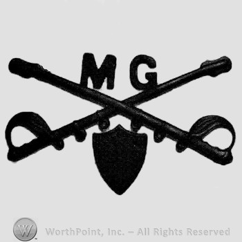 Insignia consisted of crossed sabres and letters MG at the intersection; shield below.