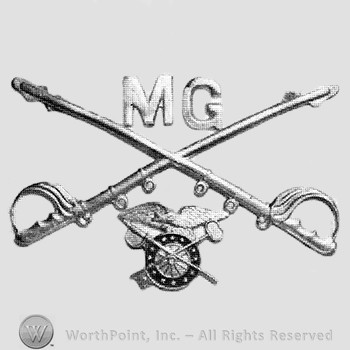 Insignia consisted of crossed sabres and letters MG at the intersection; winged wheel below.