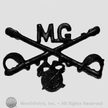 Insignia consisted of crossed sabres and letters MG at the intersection; winged wheel below.