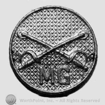 Insignia consisted of collar disc with crossed sabres on and letters  MG below the intersection.