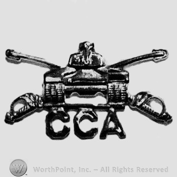 Insignia consisted of crossed sabres, front view of a tank and letters CCA.