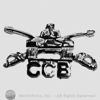 Insignia consisted of crossed sabres, front view of a tank and letters CCB.
