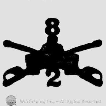 Insignia consisted of crossed sabres, front view of a tank and number 8 above and number 2 below.