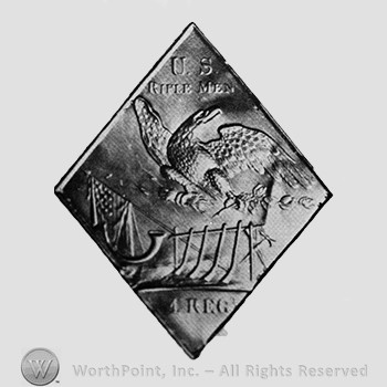 Insignia consisted of a plate with an eagle over a rack of arms, flag and powder horn; the top of the plate has US RIFLEMEN and the bottom 1 REGT.