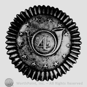 Insignia consisted of a plate, round cockade type design with a bugle surrounded by 13 stars; number 4  within the curve of the bugle.