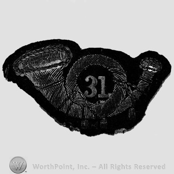 Insignia consisted of an embroidered horn with number 31 within the loop of the horn, all upon a black velvet background.