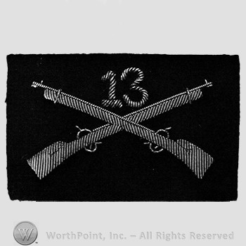 Insignia consisted of crossed rifles and number 13 above the intersection.