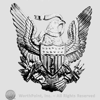 Insignia consisted of eagle gold-plated, with detachable shield and rifles worn with regimental number in silver on the shield; arrows and branch in the claws of the eagle and a ribbon in the beak; number 1 on the shield.
