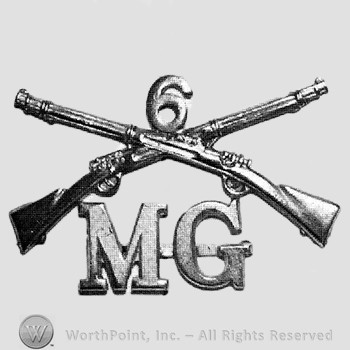 Insignia consisted of crossed rifles, number 6 above the intersection and letters MG below.