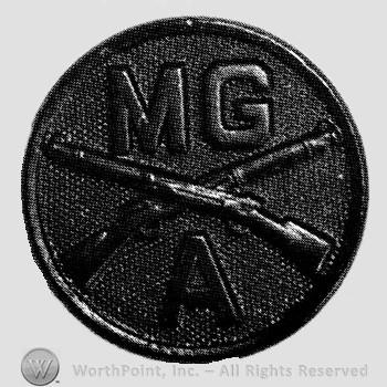 Insignia consisted of disc with crossed rifles on, letters MG above the intersection and letter A below.
