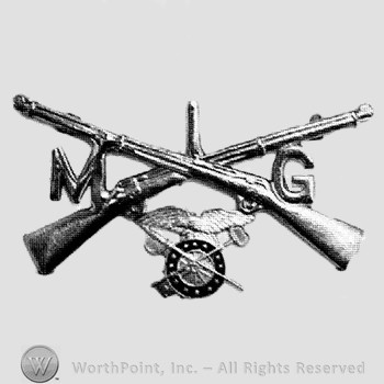 Insignia consisted of crossed rifles, number 1 above the intersection, wheel with wings below and letters M and G on the right and on the left.
