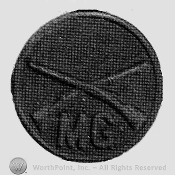 Insignia consisted of crossed rifles and letters MG below, all on a disc.