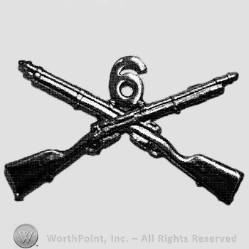 Insignia consisted of crossed rifles and number 6 above the intersection.