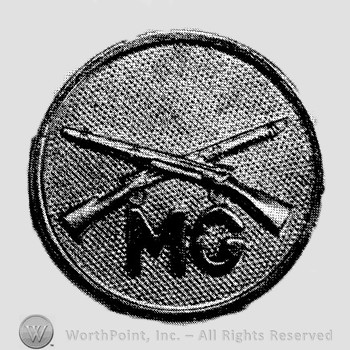 Insignia consisted of crossed rifles and letters MG below the intersection, all on a disc.
