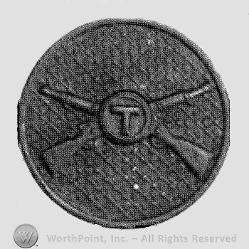 Insignia consisted of crossed rifles and letter T over the intersection; all on a disc.