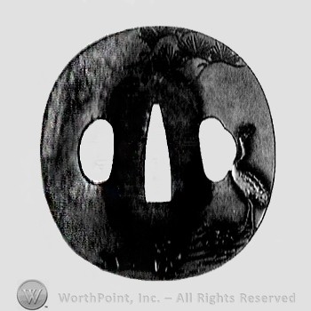 Brass Tsuba with tree branch to top and raised relief strok to right side.