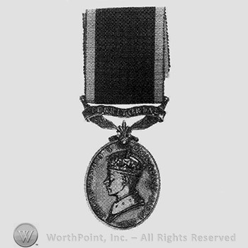British eficiency medal; TERRITORIAL written above and man' s head on the medal.