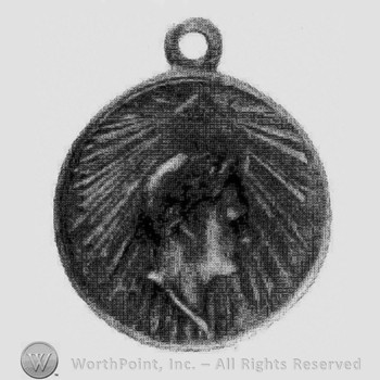 Medal with a man's head on it.