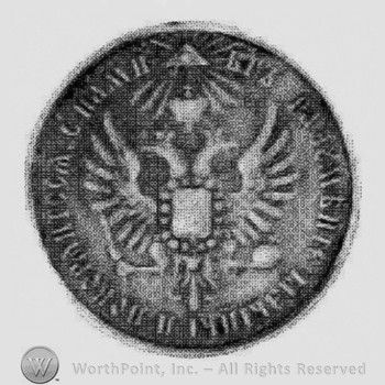 Medal with two headed eagle with a shield and russian characters on the edge.
