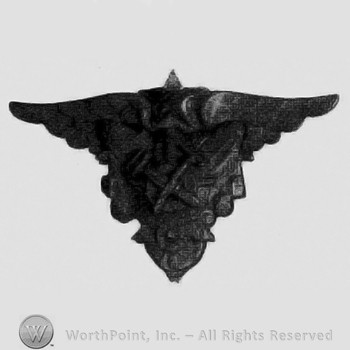 Star with wings above crossed tools.