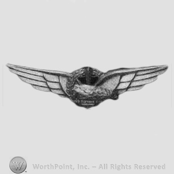 Spread wing eagle, wreath & Roman sword.