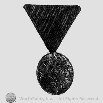 Medal in oval form; sunrise over a landscape.