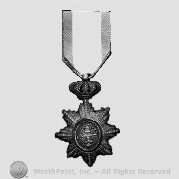 Sunburst in oval form; pierced crown suspension.
