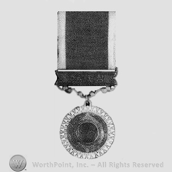 Medal with ying-yang in center.
