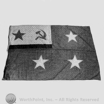 Flag with four stars and a sickle and hammer.