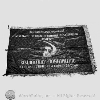 Sickle and hammer on a flag; russian characters.