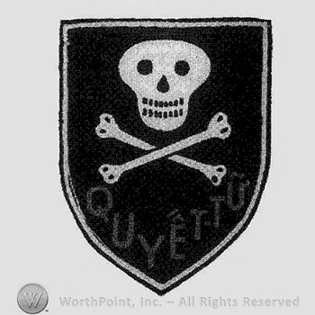 Black & white cotton shield skull over crossbones & red title below.