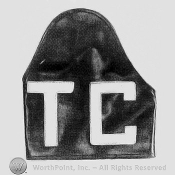 Letters TC over a guard armband.