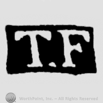 The letters TF written in uppercase