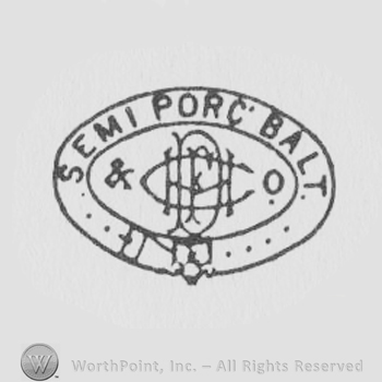 a leather belt in an oval shape SEMI PORCELAIN and the letters DMFCO written overlapped inside