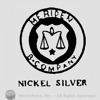 A circle enclosing a balance on a shield and a little star, Meriden B. Company written around with uppercase letters. 
