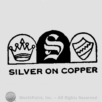 A crown in the left side; letter S written in the middle; a shield on the right side; SILVER ON COPPER written bellow.