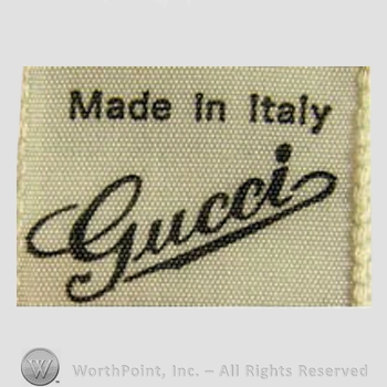 Clothing label : Guccio Gucci.