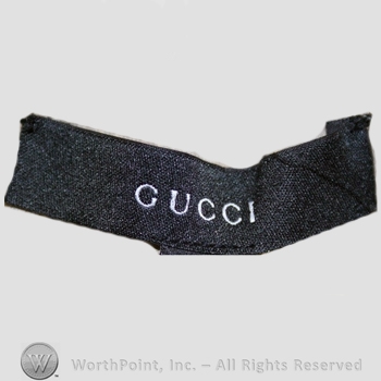 Clothing label : Guccio Gucci.
