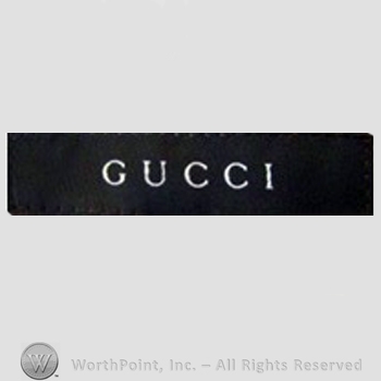 Clothing label : Guccio Gucci.
