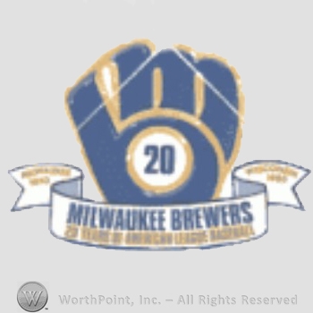 Milwaukee Brewers sport logo: MB together in the shape of a baseball glove above "Milwaukee Brewers 20 years american league baseball" written on a ribbon.