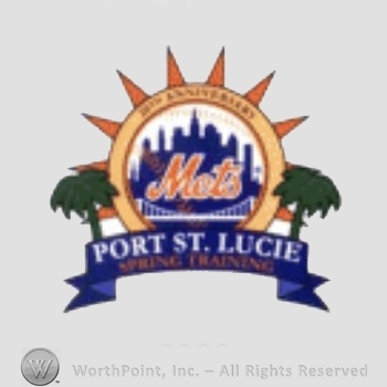 New York Mets sport logo: Mets above a bridge in front of New York Skyline, all on a baseball; Port St. Lucie Spring Training written below and two palms each side.