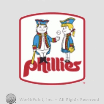 Philadelphia Phillies sport logo: mascots of the era, shown wearing 18th century outfits and playing baseball; phillies written below.