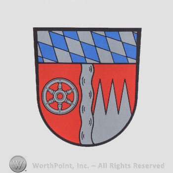 Heraldry: shield, diamond pattern, wheel, waving line, dents.